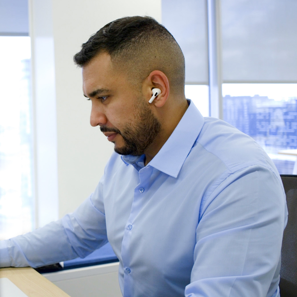 Man wearing headphones working at his computer