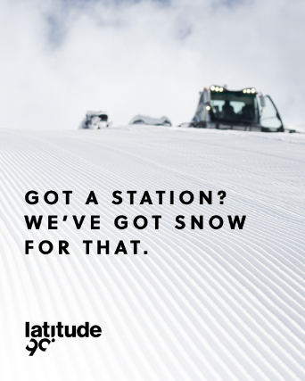 Snow groomer above a ski slope. Visual entitled Got a station?