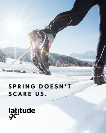 Legs of a skier seen up close on pristine snow. Visual entitled Spring doesn't scare us