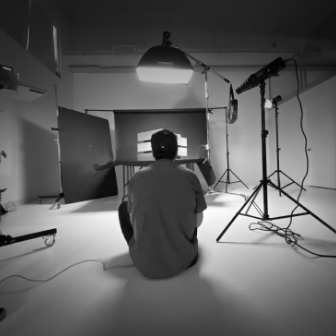 Photographer seated taking pictures of drawers